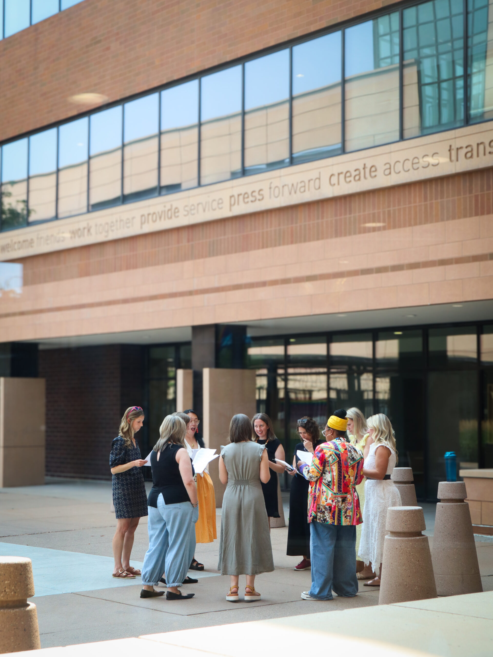ECO Cohort 10 participants gathered in a circle for a group activity outside the Wilder Foundation.